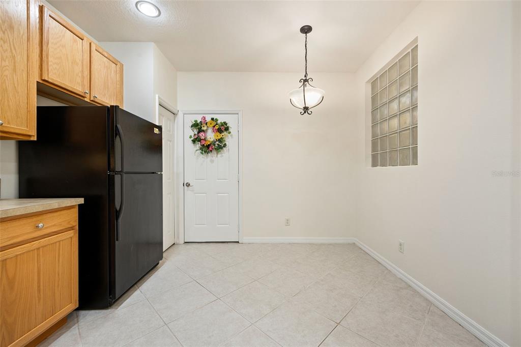 3956 Cherrybrook Loop Fort Myers, FL 33966 - Photo 8 of 44 a view of empty room with a refrigerator cabinets and a ceiling fan