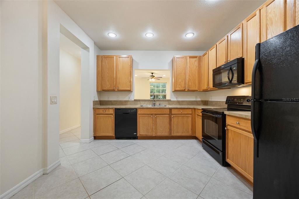 3956 Cherrybrook Loop Fort Myers, FL 33966 - Photo 9 of 44 a kitchen with stainless steel appliances granite countertop a refrigerator sink and microwave