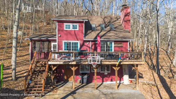 a view of a chairs and table in the backyard