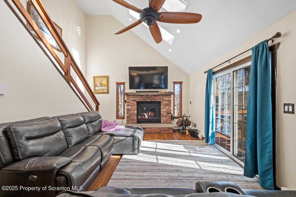 3110 Cherry Ridge Road Bushkill, PA 18324 - Photo 16 of 61 a living room with furniture a flat screen tv and a fireplace