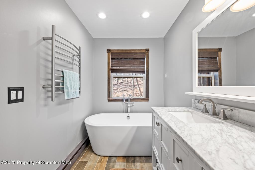 3110 Cherry Ridge Road Bushkill, PA 18324 - Photo 23 of 61 a bathroom with a granite countertop sink mirror and tub