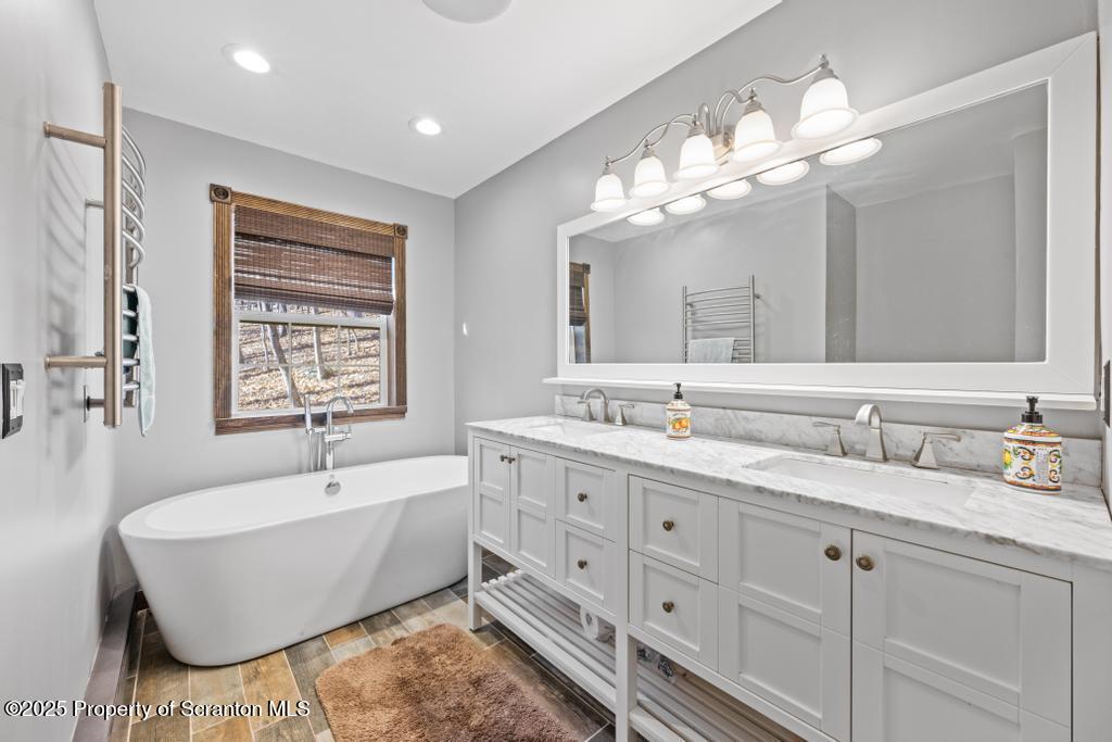 3110 Cherry Ridge Road Bushkill, PA 18324 - Photo 24 of 61 a bathroom with double vanity sink a bathtub and a mirror