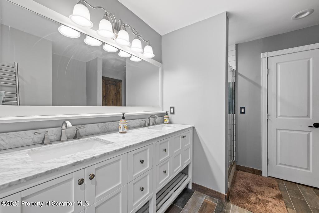 3110 Cherry Ridge Road Bushkill, PA 18324 - Photo 25 of 61 a bathroom with a granite countertop double vanity sink and a mirror