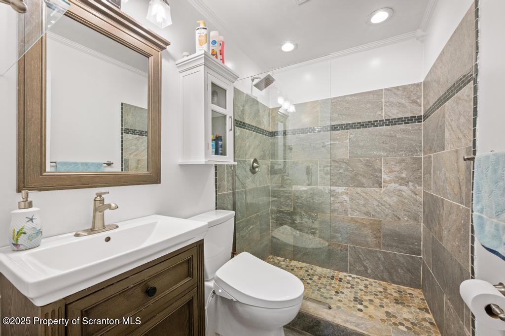 3110 Cherry Ridge Road Bushkill, PA 18324 - Photo 32 of 61 a bathroom with a sink toilet a mirror and shower