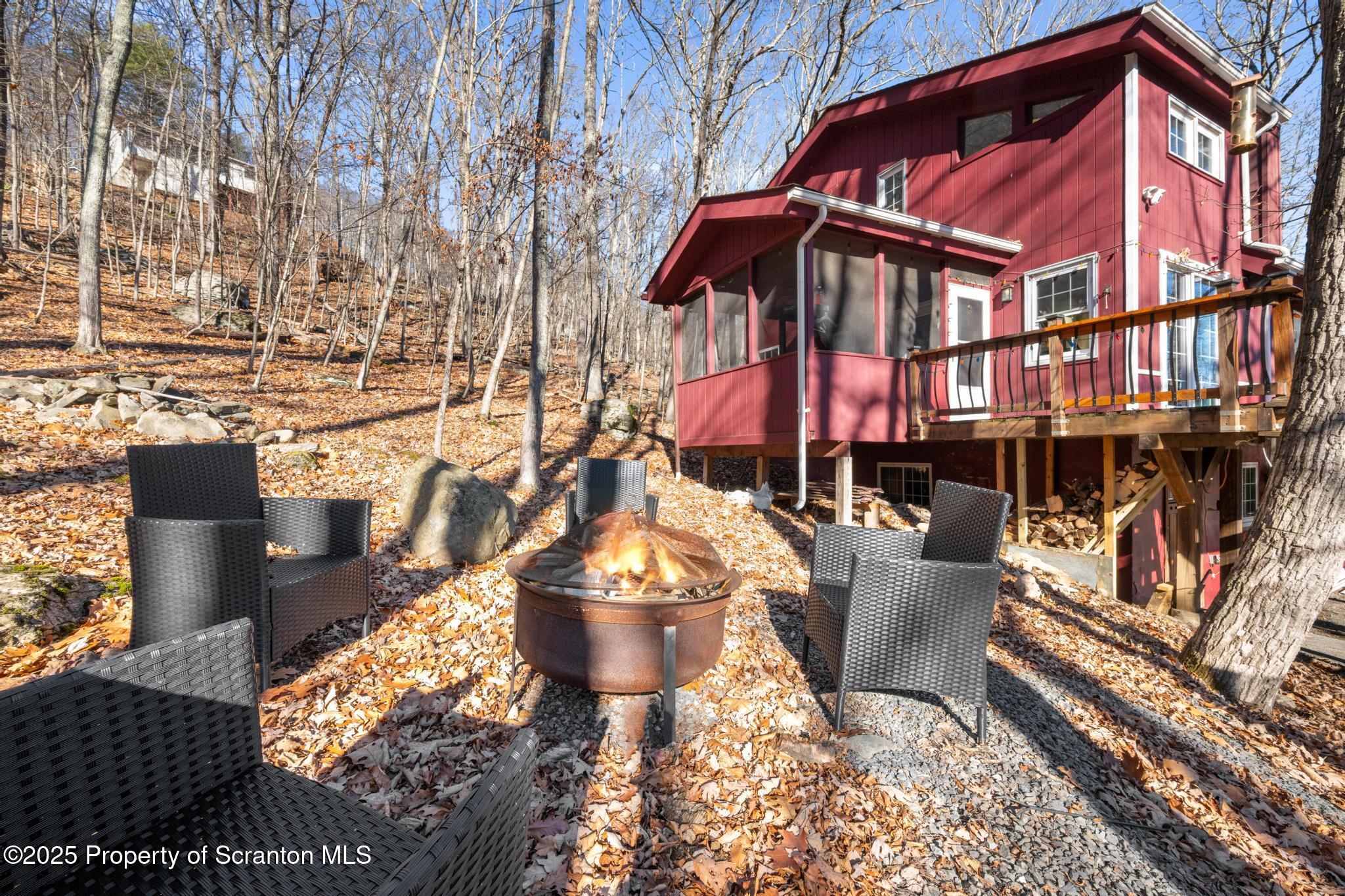 3110 Cherry Ridge Road Bushkill, PA 18324 - Photo 8 of 61 a view of a chairs and table in the patio