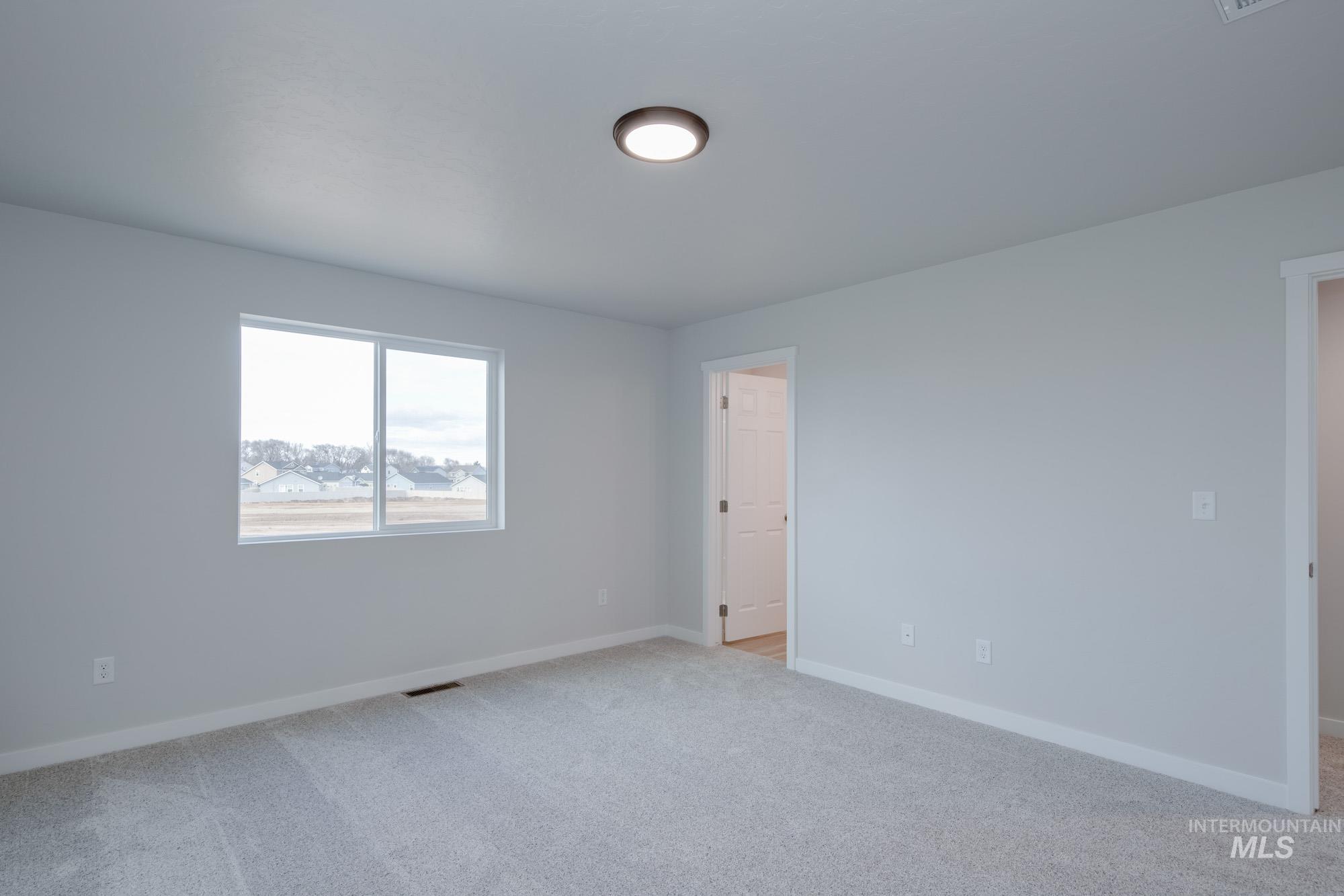 3089 South Maple Rnch Way Nampa, ID 83686 - Photo 13 of 22 Carpeted spare room with baseboards