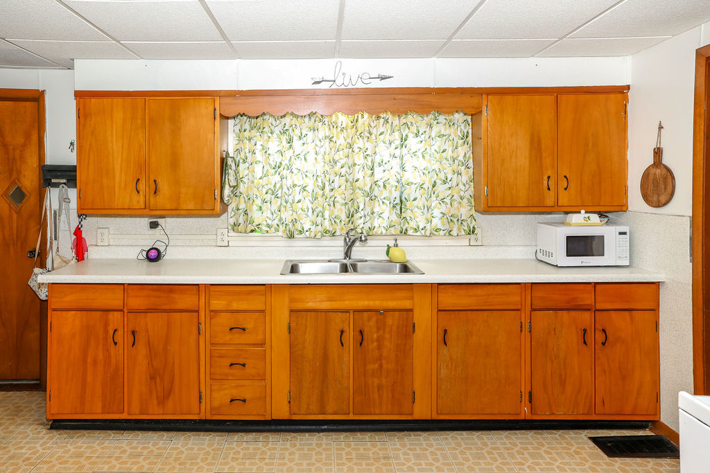 415 East Elm Street Chatsworth, IL 60921 - Photo 2 of 38 a kitchen with wooden cabinets and a sink