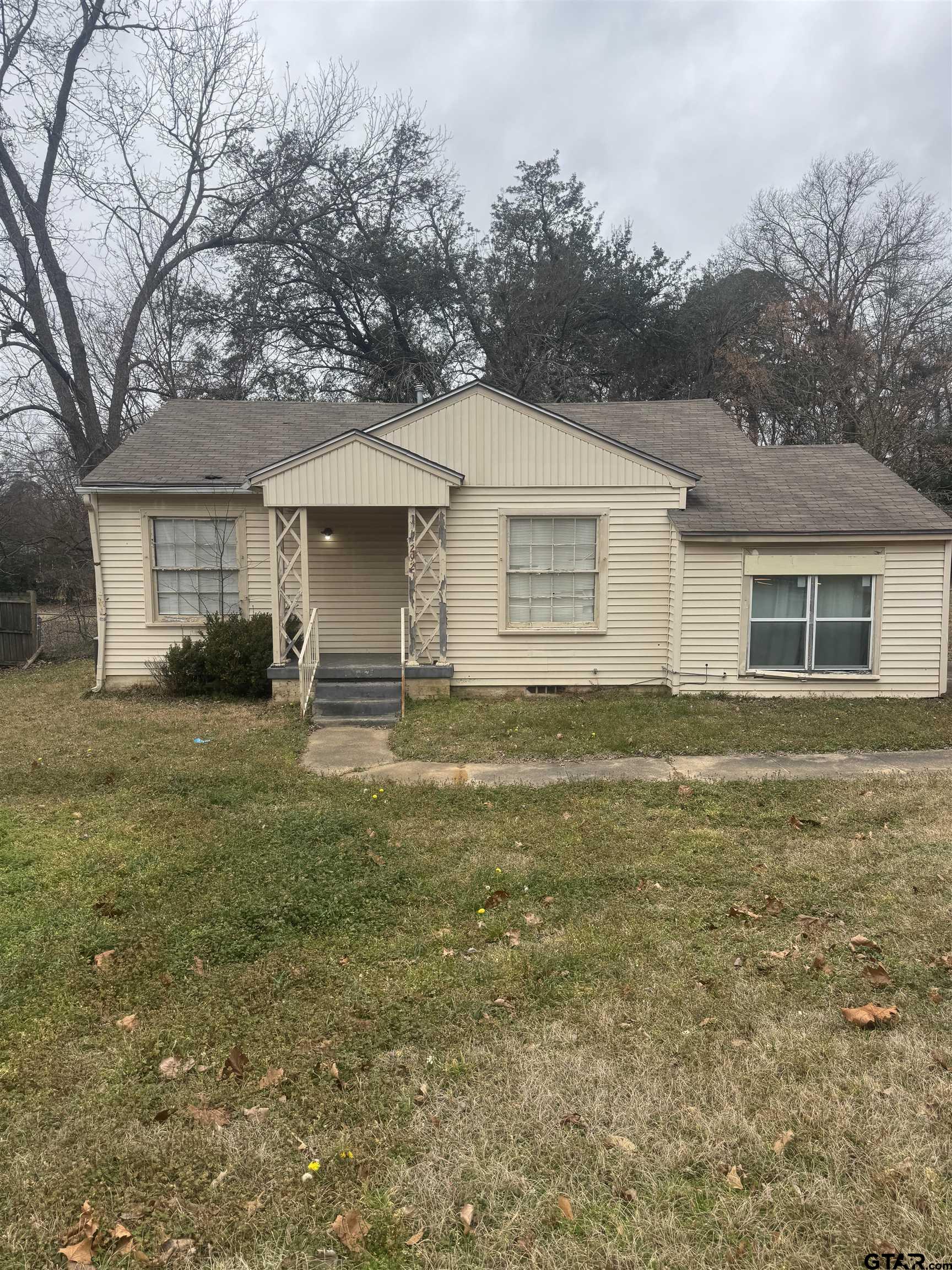 2927 New Copeland Road Tyler, TX 75701 - Photo 6 of 12 a house that has a big yard large trees with wooden fence