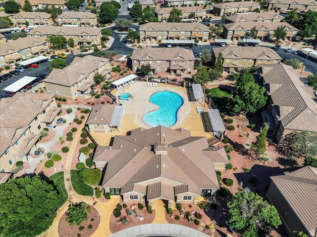 3155 South Hidden Dr Street, Unit 248 St. George, UT 84790 - Photo 20 of 24 Community featuring a central amenity area with a kidney-shaped swimming pool, circular spa, and surrounding lounge seating