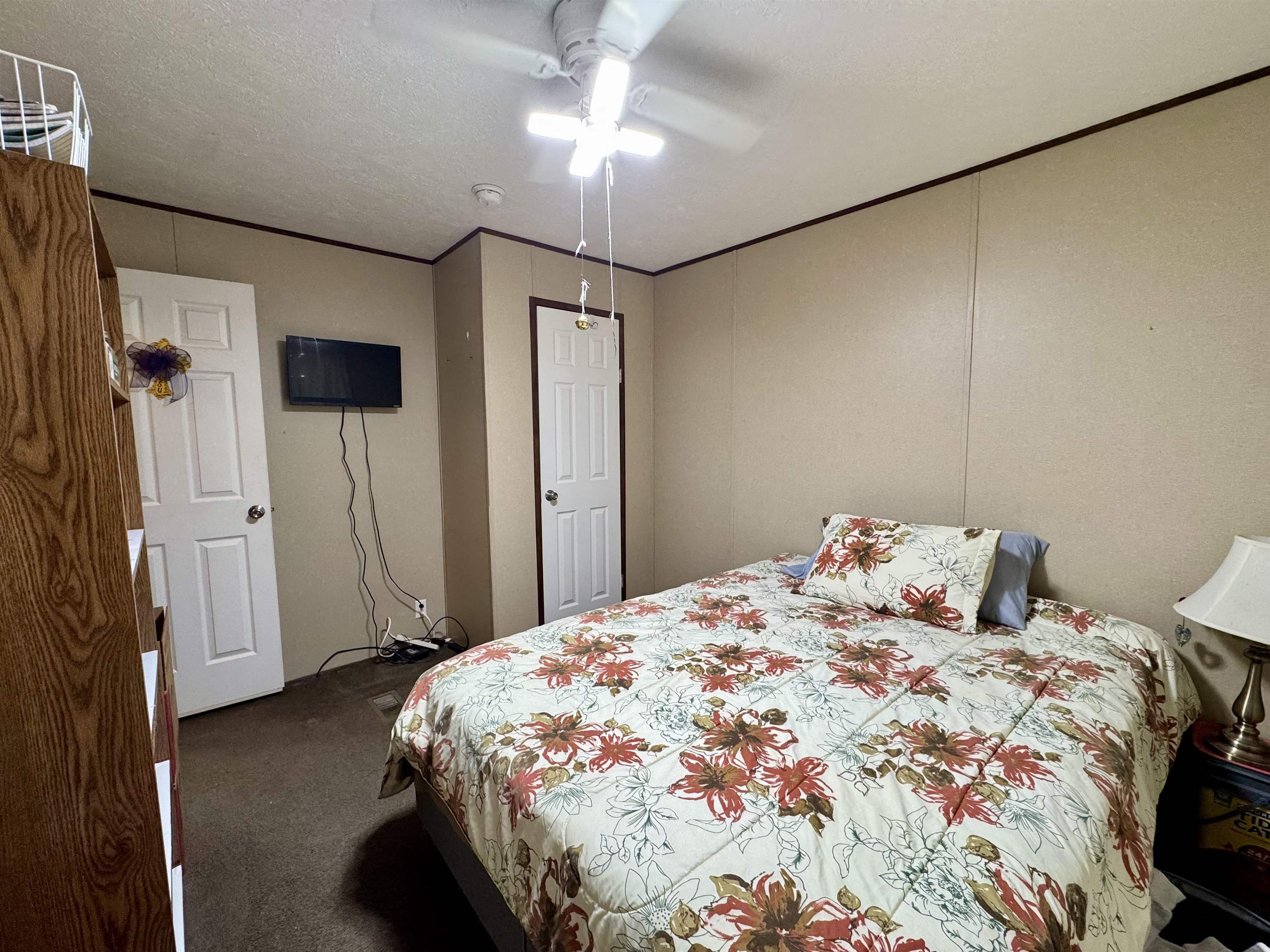 125 Elam Way Savannah, TN 38372 - Photo 14 of 36 Bedroom with dark carpet, a textured ceiling, and a ceiling fan