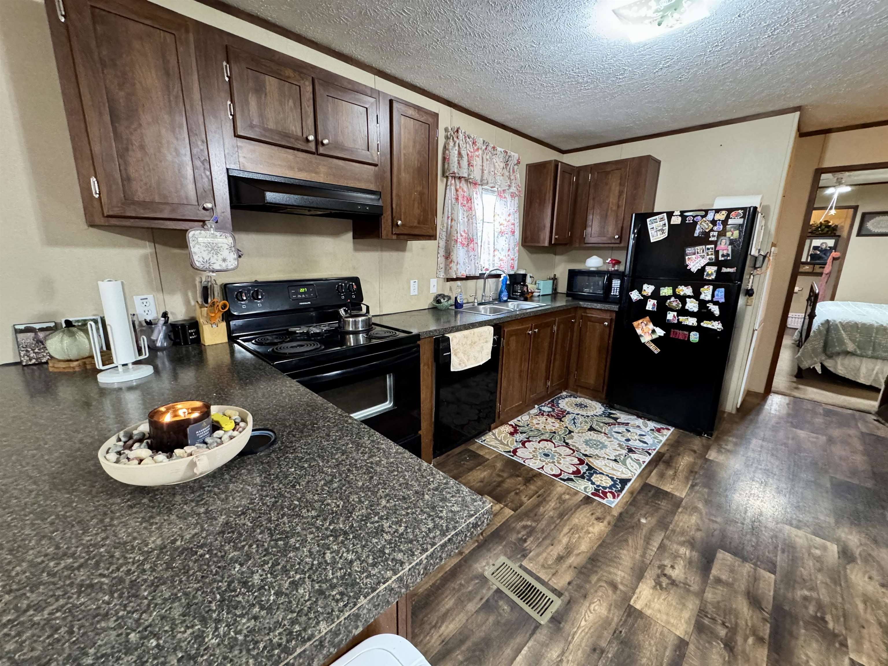 125 Elam Way Savannah, TN 38372 - Photo 15 of 36 a kitchen with stainless steel appliances kitchen island granite countertop a refrigerator stove and sink