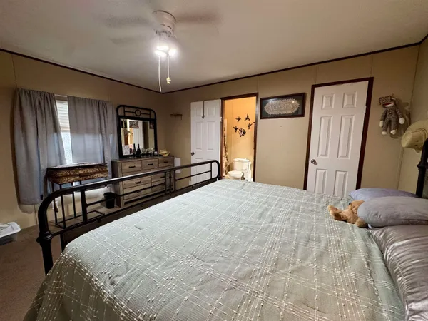 a bedroom with a large bed and a chandelier