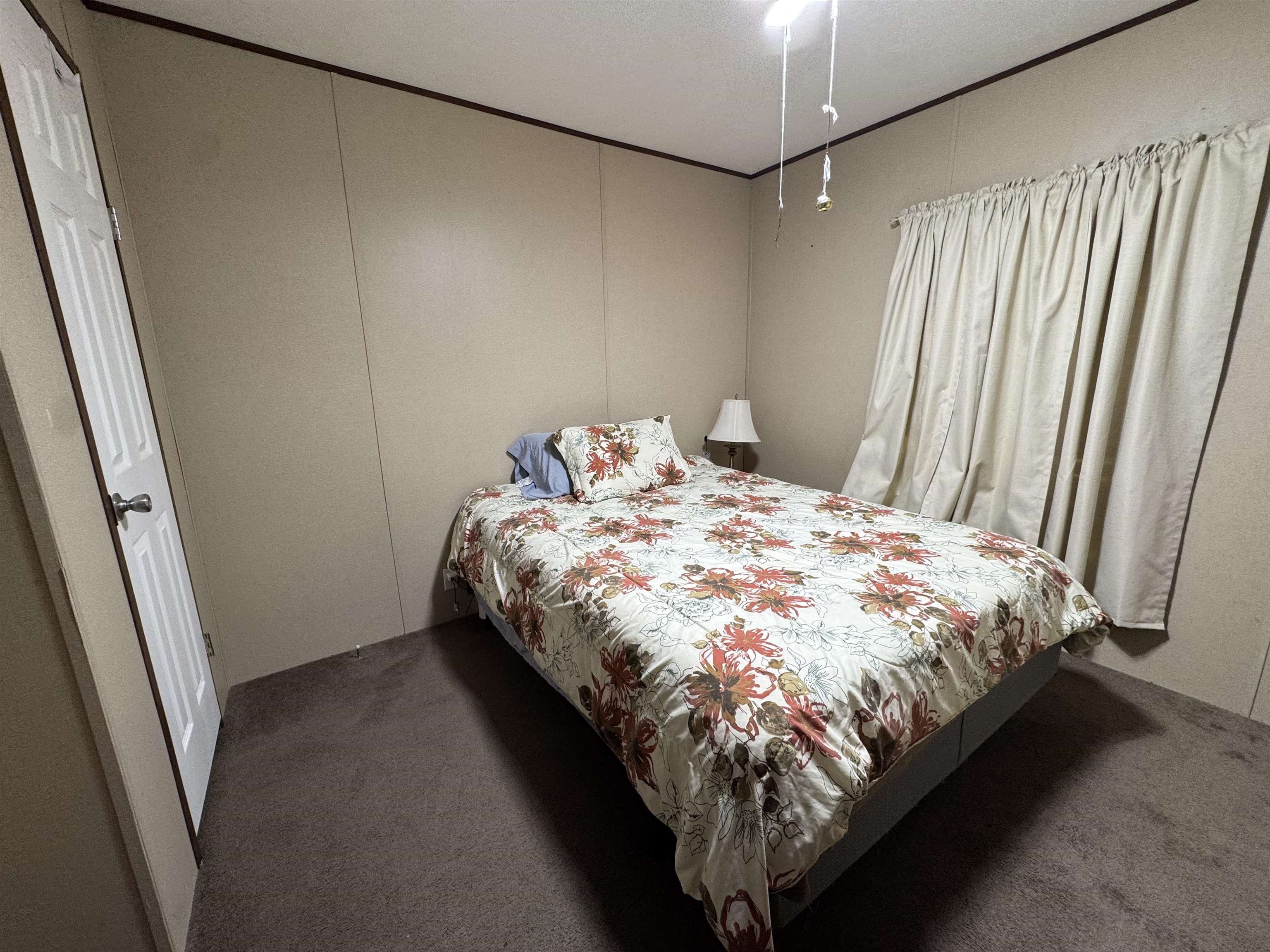 125 Elam Way Savannah, TN 38372 - Photo 22 of 36 a bed sitting in a bedroom next to a window