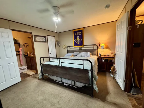 a bedroom with furniture and a mirror