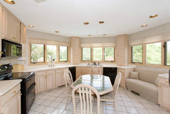 11737 Prestwick Road Belvidere, IL 61008 - Photo 3 of 6 a large white kitchen with granite countertop a stove a sink a dining table and chairs