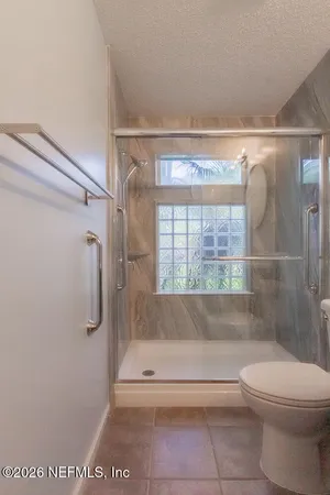 a bathroom with a shower a toilet and a shower