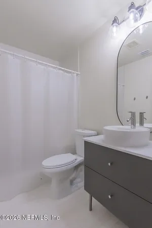 a bathroom with a sink a toilet and mirror