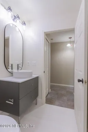 a bathroom with a sink a mirror and a shower