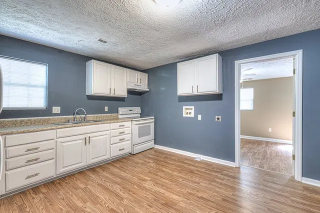 a spacious bathroom with a granite countertop sink and a mirror