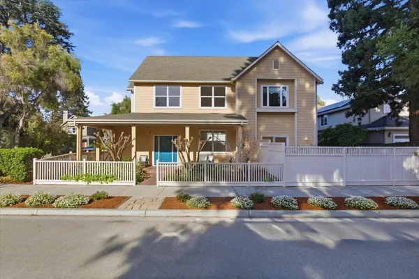 a front view of a house with a yard and a garage
