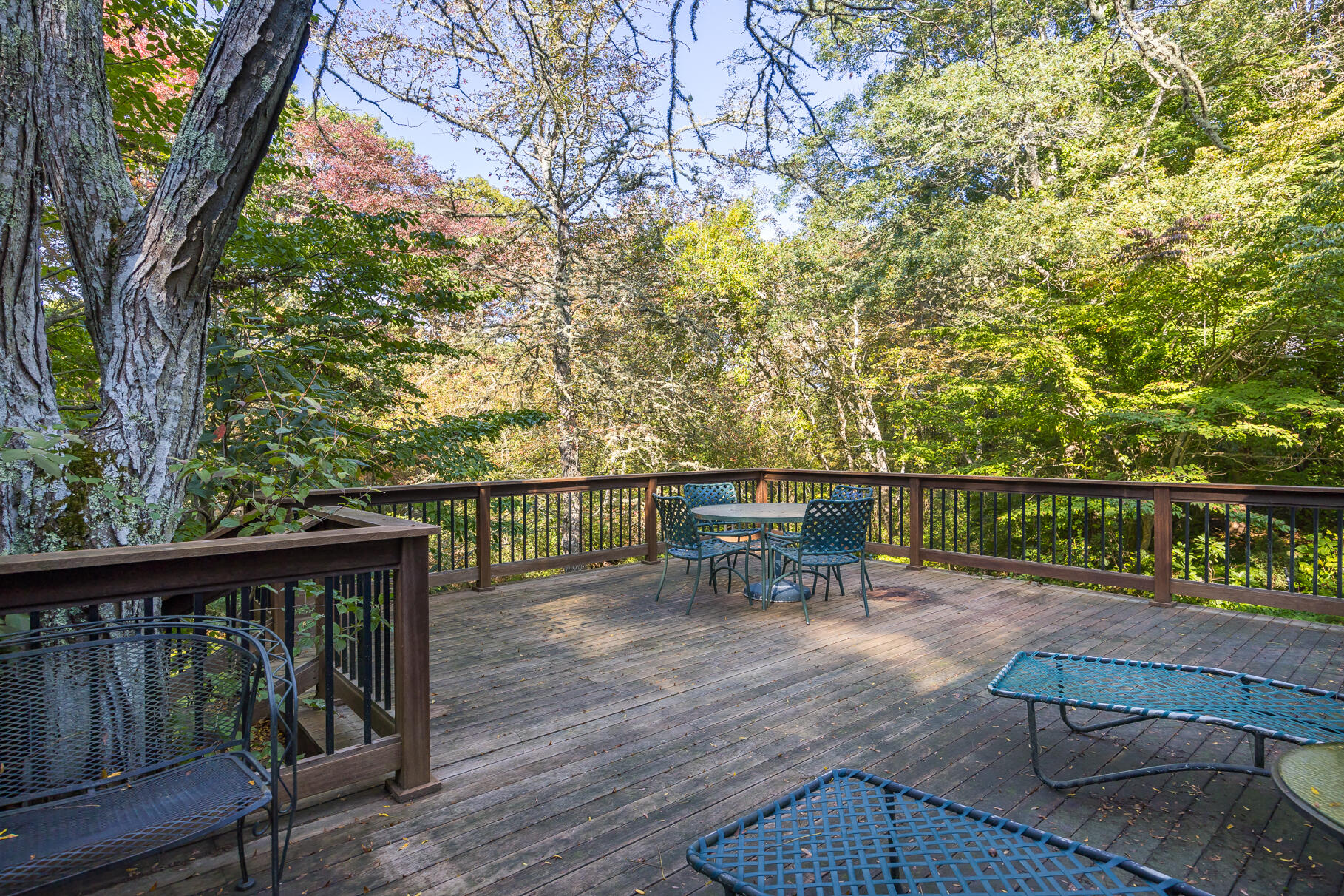 72 Hathaway Road Osterville, MA 02655 - Photo 17 of 40 a view of a chairs and table on the wooden deck