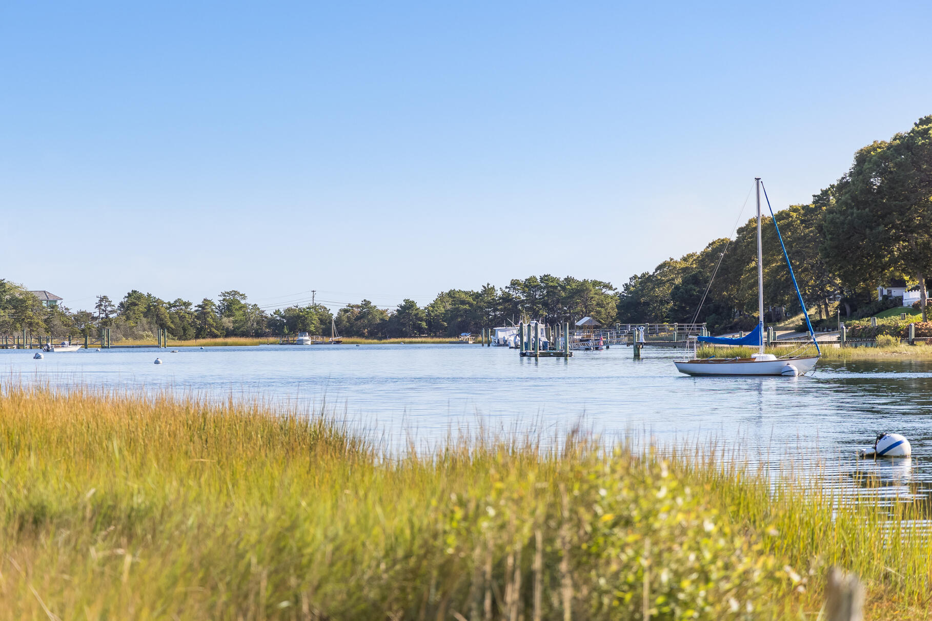 72 Hathaway Road Osterville, MA 02655 - Photo 3 of 40 a view of a lake with a yard and mountain view