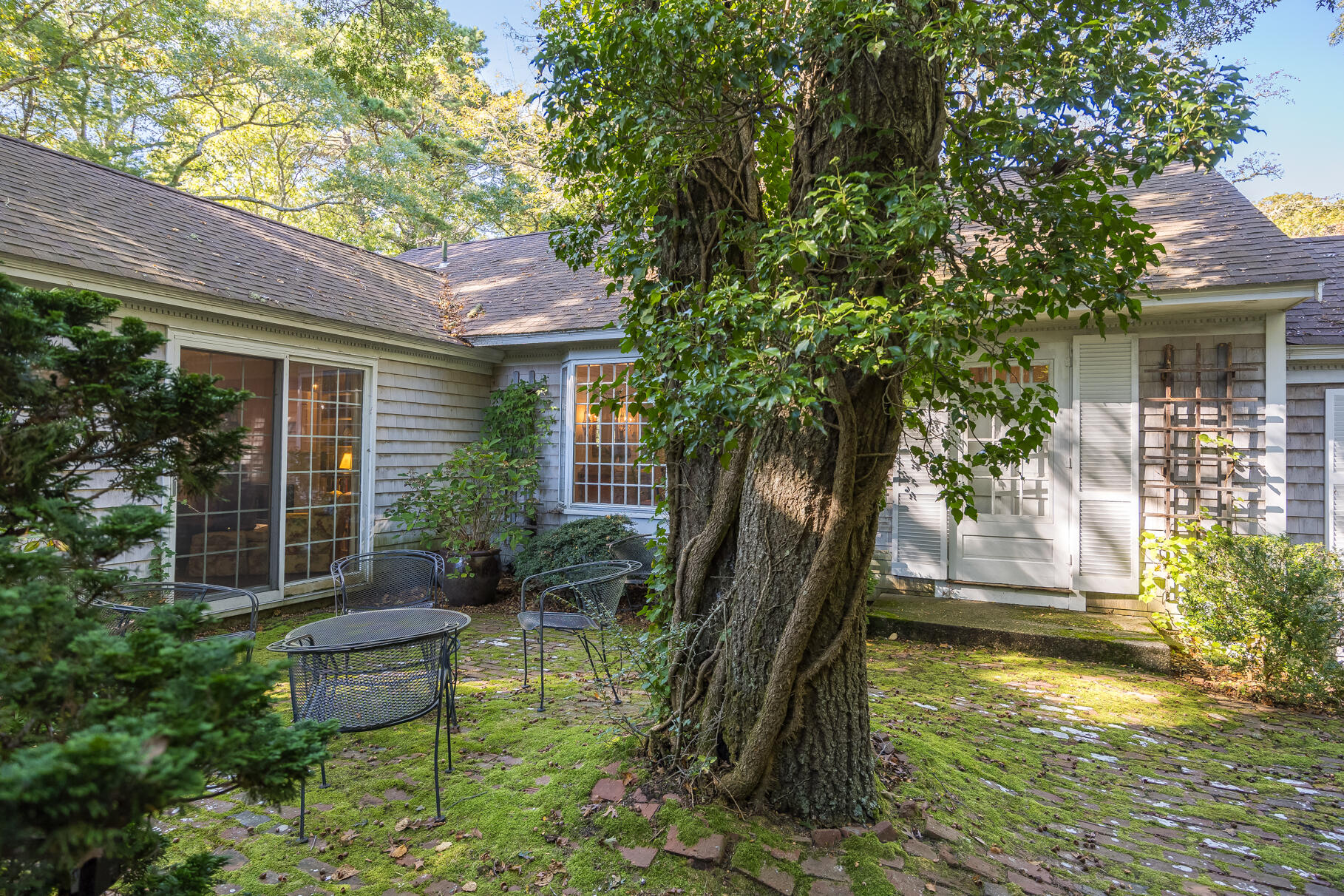72 Hathaway Road Osterville, MA 02655 - Photo 37 of 40 a backyard of a house with yard and outdoor seating