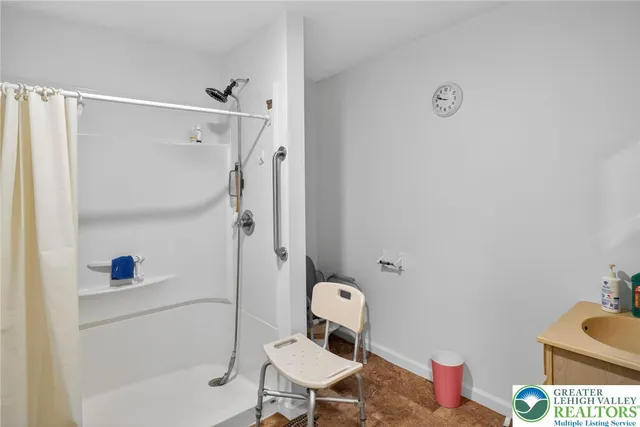 a bathroom with a toilet and a shower