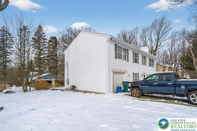 a view of a car park in front of a house