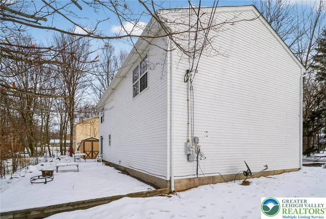 a view of a house with snow on the road