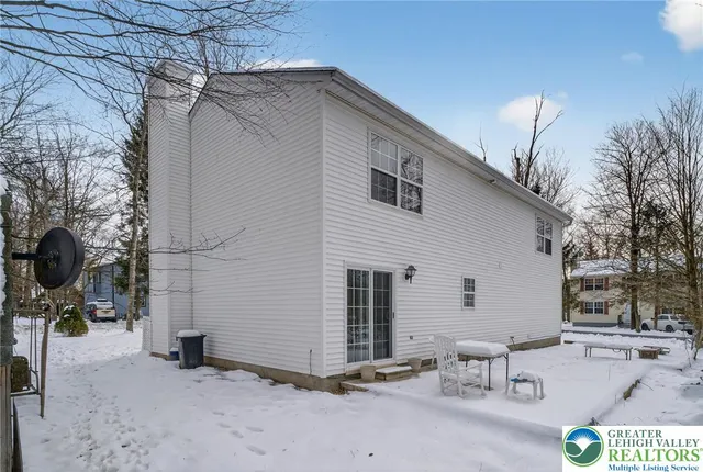 a view of a patio with table and chairs with wooden floor and fence