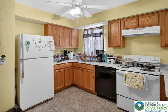 a kitchen with a refrigerator a stove a microwave and cabinets