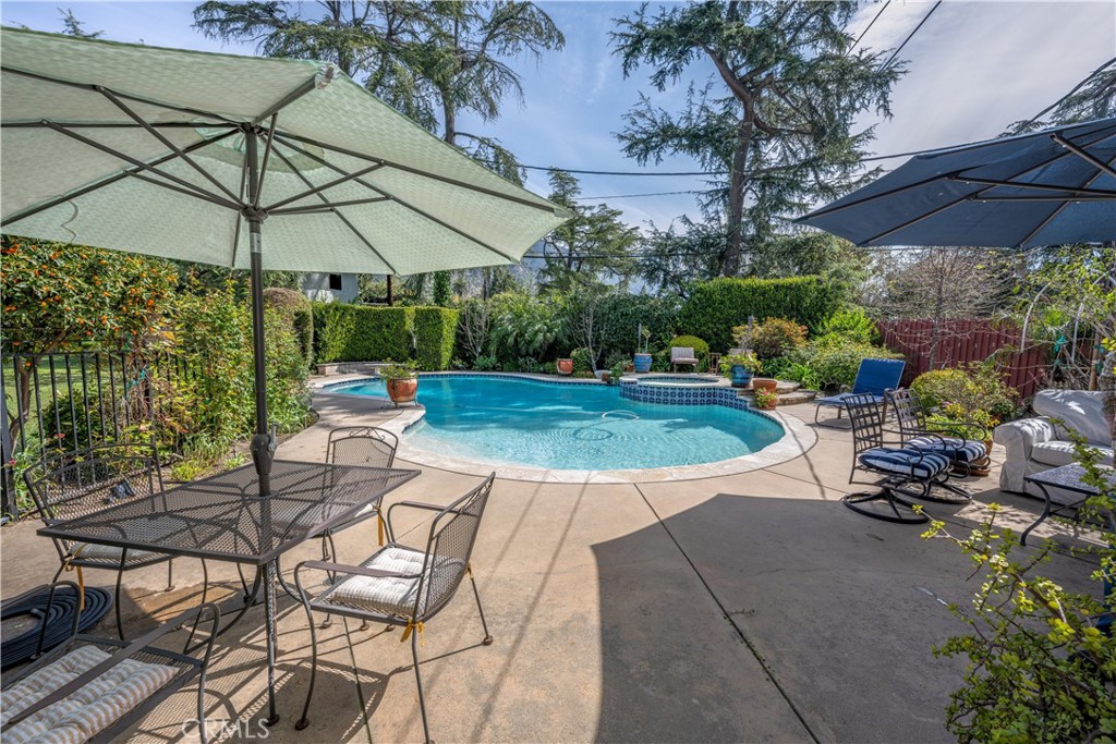 1865 Midwick Drive Altadena, CA 91001 - Photo 27 of 30 a view of patio with chairs and table under an umbrella