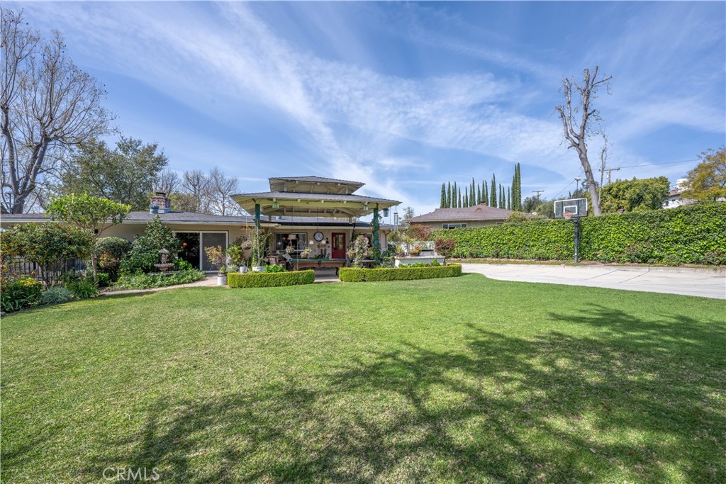 1865 Midwick Drive Altadena, CA 91001 - Photo 3 of 30 a view of a big house with a big yard potted plants and large tree