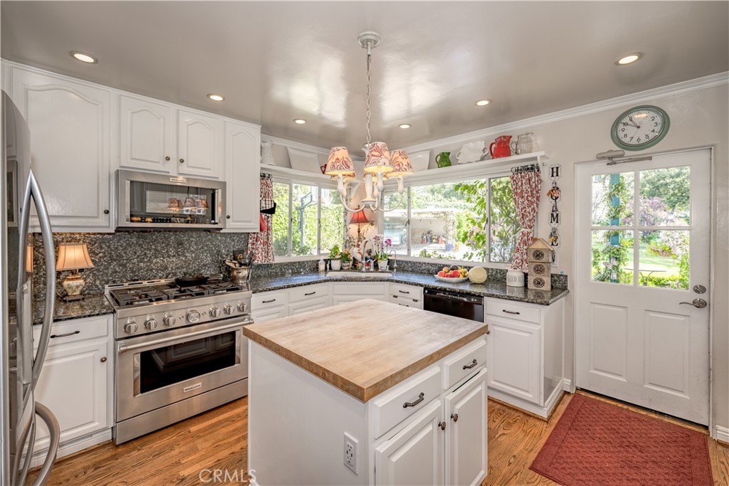 1865 Midwick Drive Altadena, CA 91001 - Photo 9 of 30 a kitchen with a stove cabinets and window