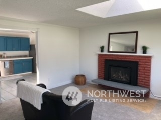 218 105th Street Southeast Everett, WA 98208 - Photo 4 of 12 a living room with furniture and a fireplace
