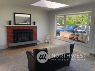 218 105th Street Southeast Everett, WA 98208 - Photo 5 of 12 a bedroom with furniture and a fireplace