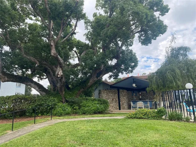 a view of a house with a yard and a garden