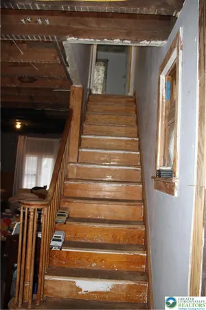 a bedroom with bed and a chair