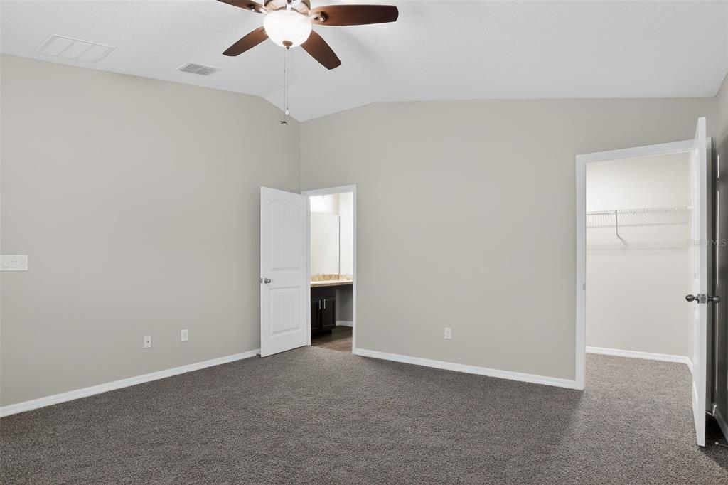 46 Sea Trail Palm Coast, FL 32164 - Photo 11 of 21 an empty room with chandelier fan and windows
