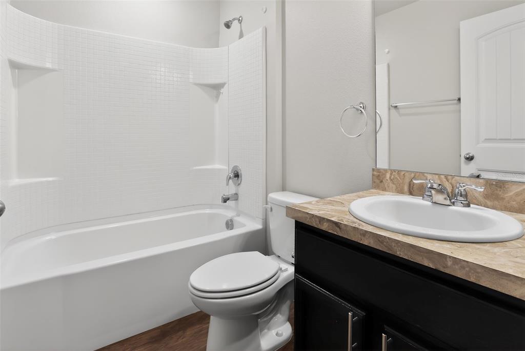 46 Sea Trail Palm Coast, FL 32164 - Photo 18 of 21 a bathroom with a granite countertop sink toilet a mirror and bathtub