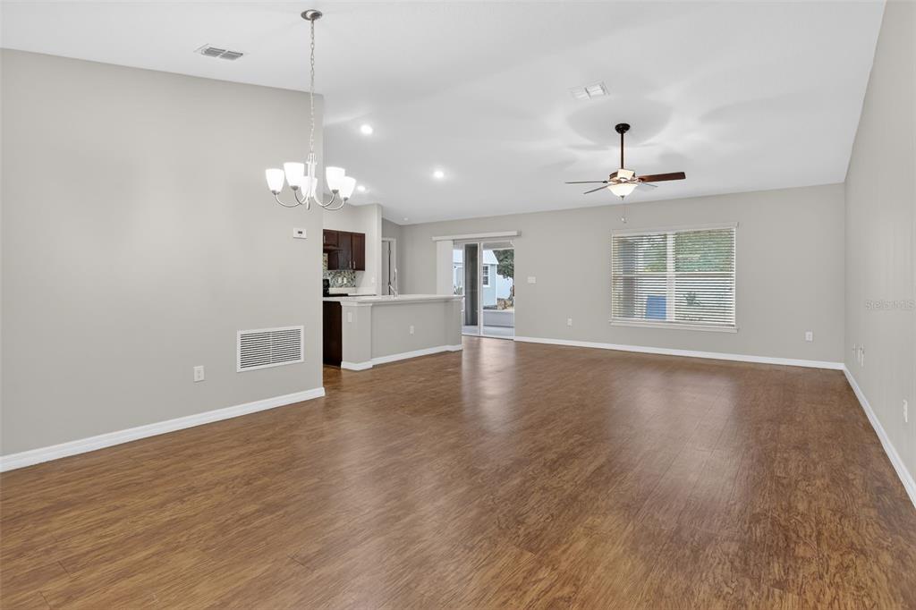 46 Sea Trail Palm Coast, FL 32164 - Photo 9 of 21 wooden floor in an empty room with a window