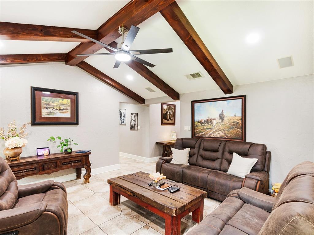 1616 Springbrook Street Mesquite, TX 75149 - Photo 18 of 24 Vaulted ceiling with exposed wood beams, ceiling fan with integrated lighting, recessed lighting, and tile flooring