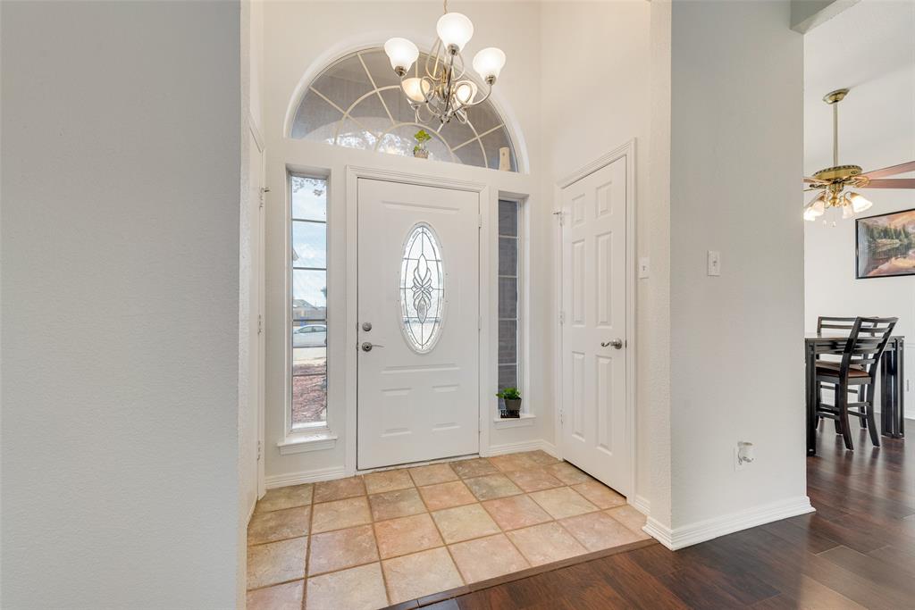 106 Villanova Circle Forney, TX 75126 - Photo 5 of 26 a view of a hallway with wooden floor and a chandelier