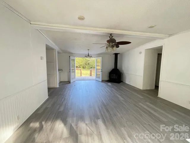 a view of a room with wooden floor and a window