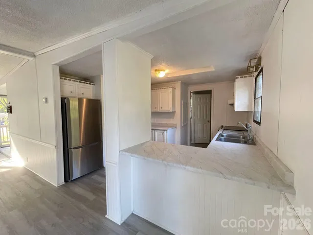 a large bedroom with a bed and a refrigerator