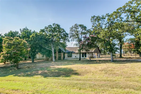 a house view with swimming pool in front of it