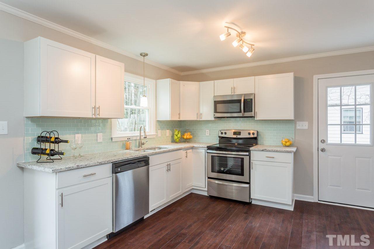 3822 Corwin Road Garner, NC 27529 - Photo 1 of 25 a kitchen with a sink a stove and microwave