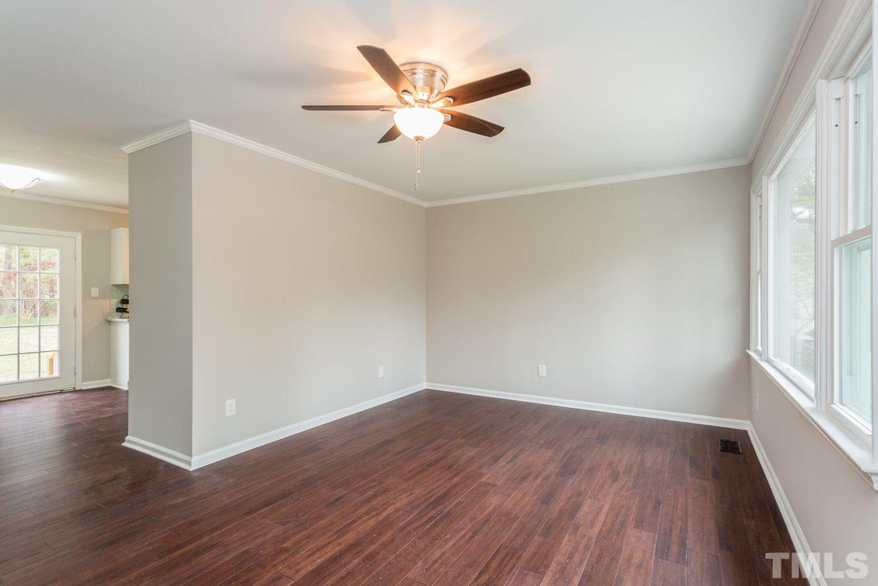3822 Corwin Road Garner, NC 27529 - Photo 11 of 25 an empty room with wooden floor and windows