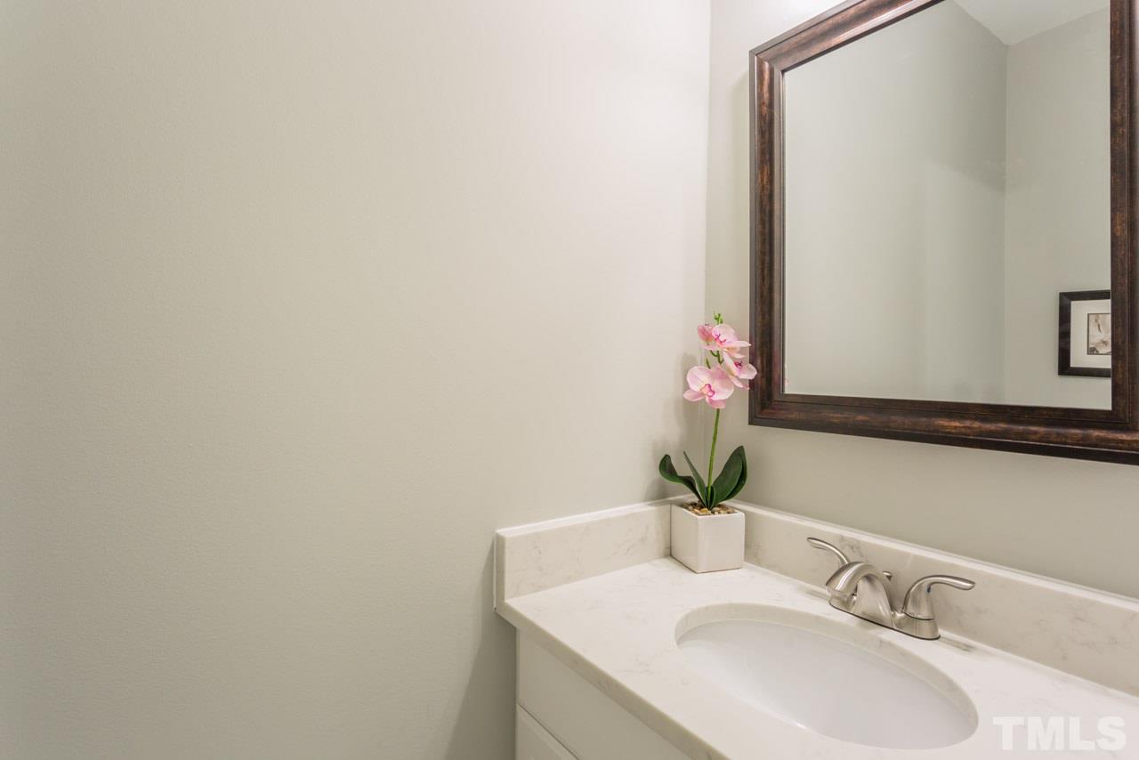3822 Corwin Road Garner, NC 27529 - Photo 19 of 25 a bathroom with a sink and a mirror